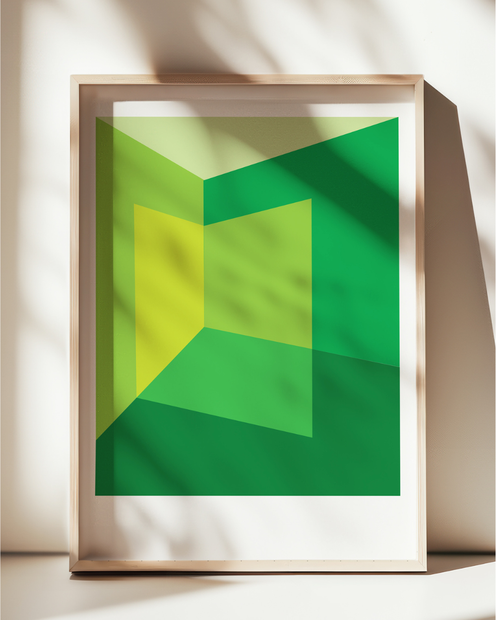 Framed abstract art with green and yellow geometric design on a light background