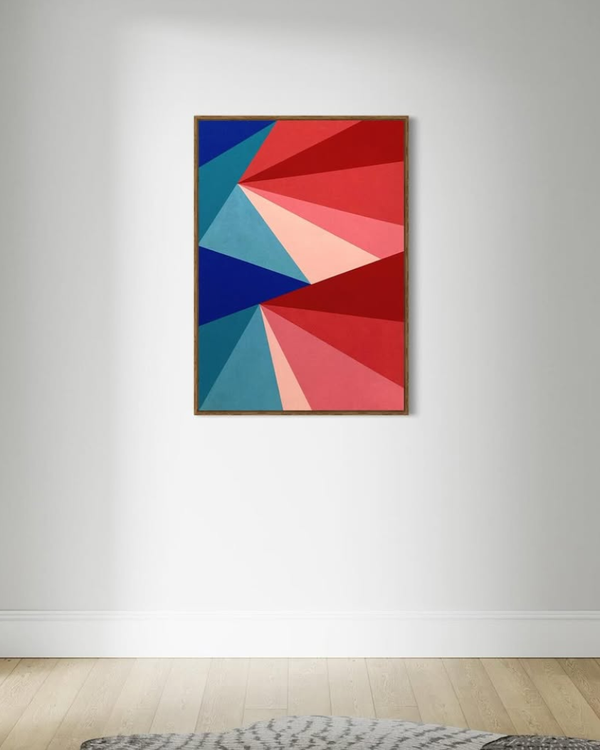 An abstract geometric painting in red, blue, and black on a white wall, with a wooden floor and a gray rug visible at the bottom.