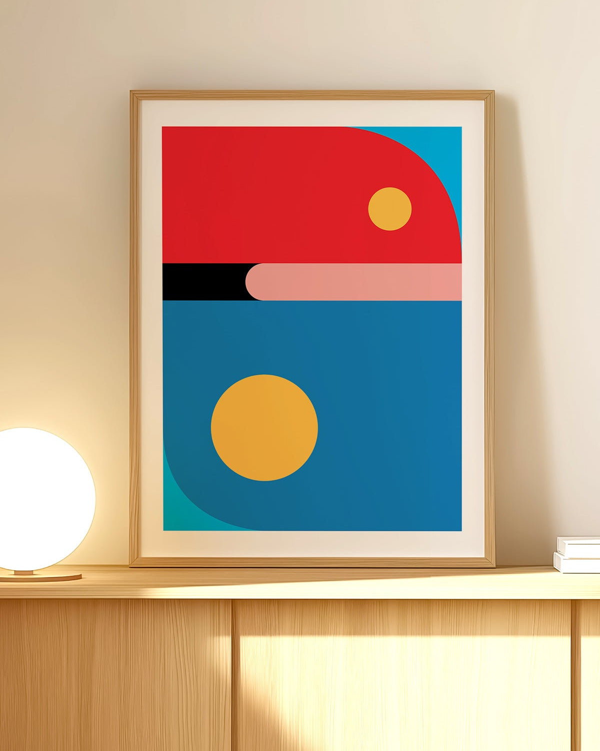 Framed abstract art print with geometric shapes on a wall