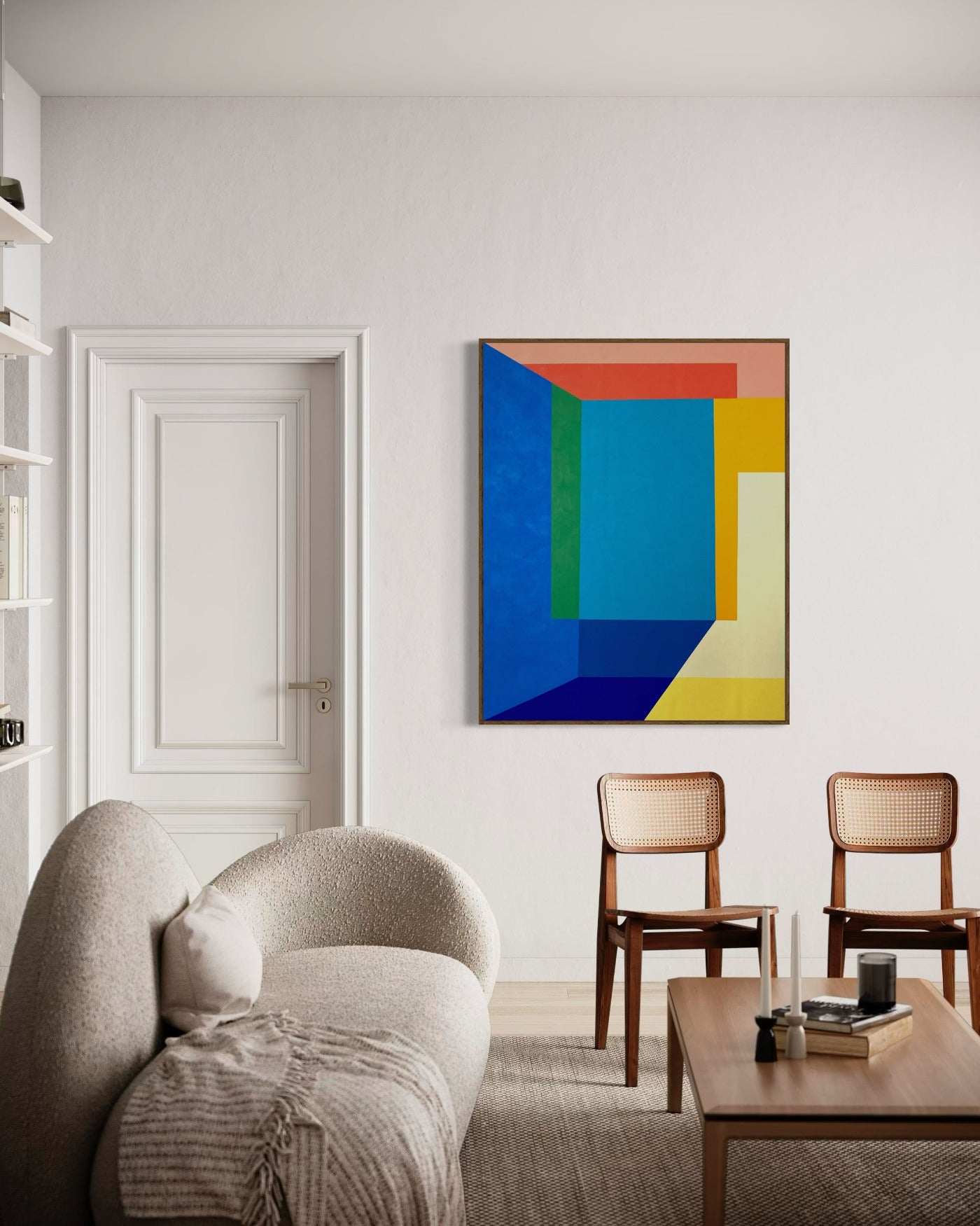 An abstract painting featuring geometric shapes in blue, orange, and green on a canvas, displayed on a wall above a neutral-colored sofa and wooden chairs.