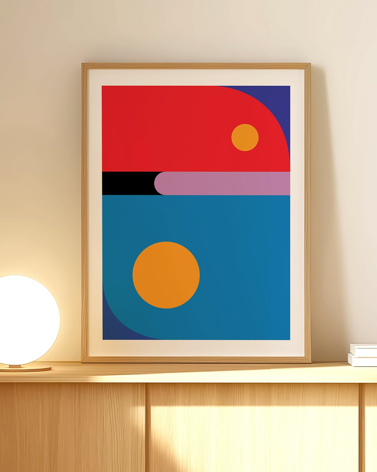 Framed abstract art print with geometric shapes on a wall