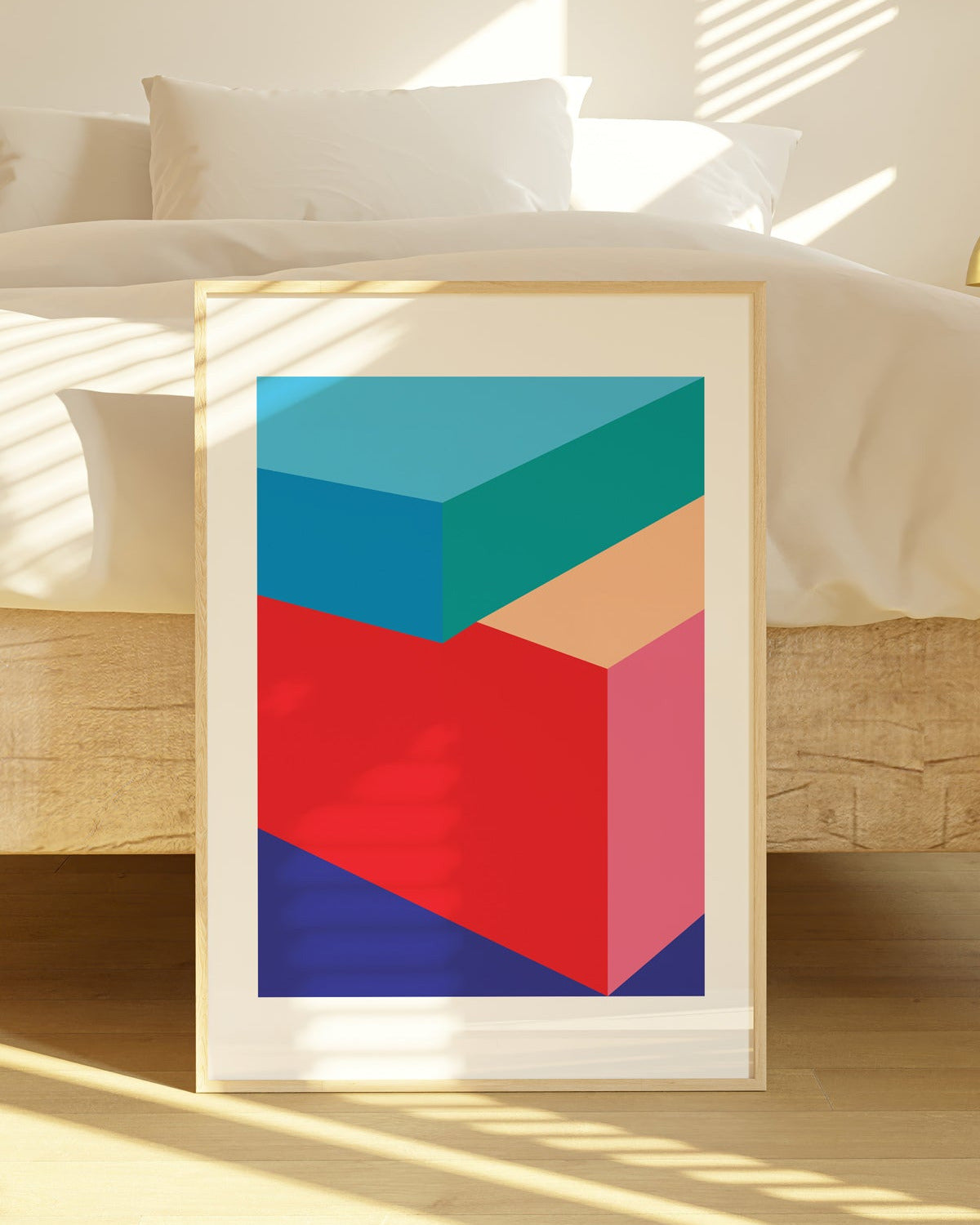 Framed abstract art print with geometric shapes on a wooden floor.