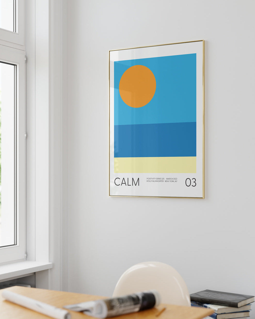 Framed abstract art print titled 'Calm' on a wall above a desk.
