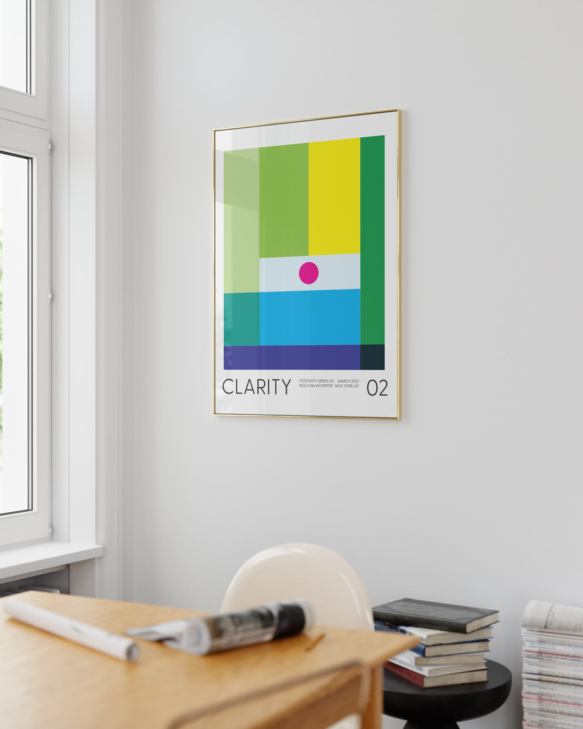 Colorful abstract poster titled 'Clarity' on a wall in a room with a desk and window.