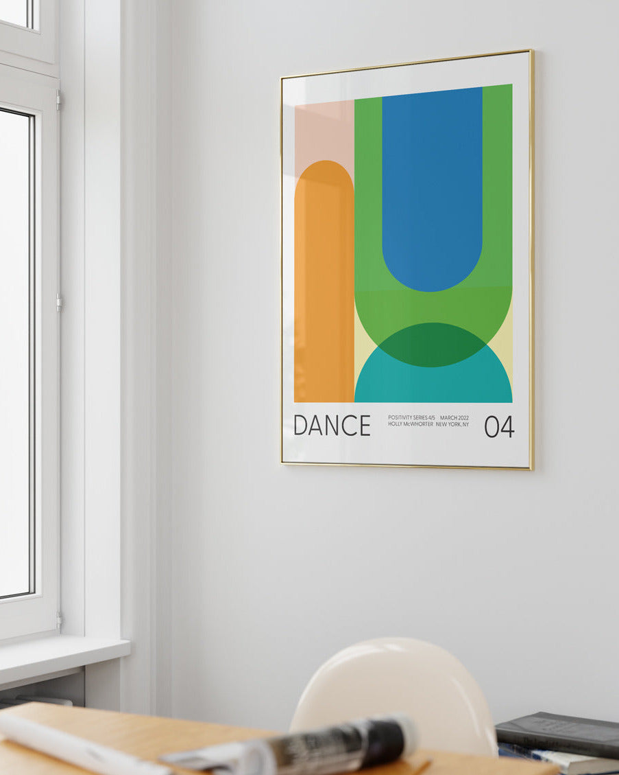 Colorful abstract poster titled 'DANCE' on a wall in a room with a desk and window.