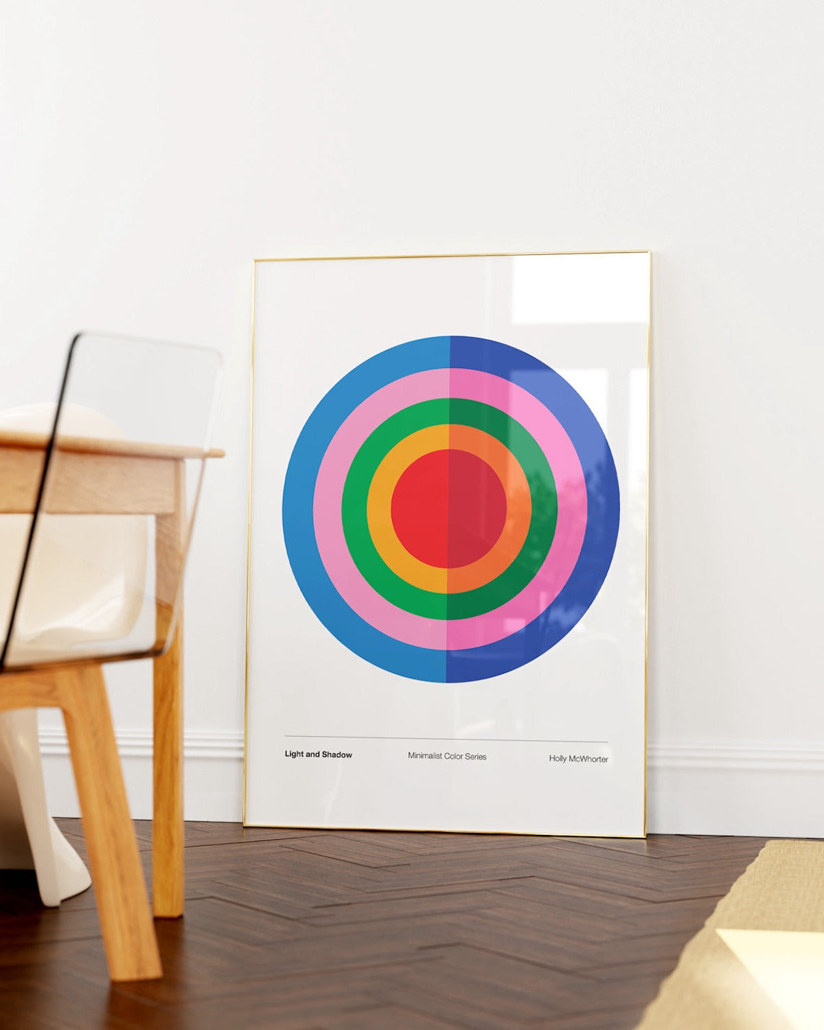 Colorful circular design poster on a white wall with a wooden chair and floor.